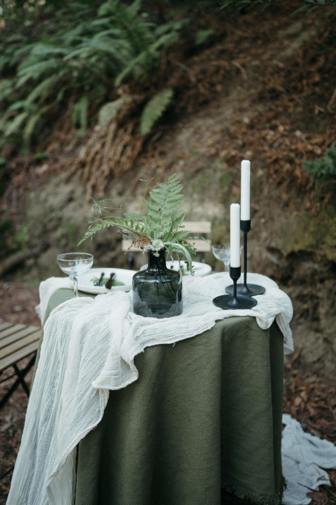 Clean and simple table set up in the redwoods for two 