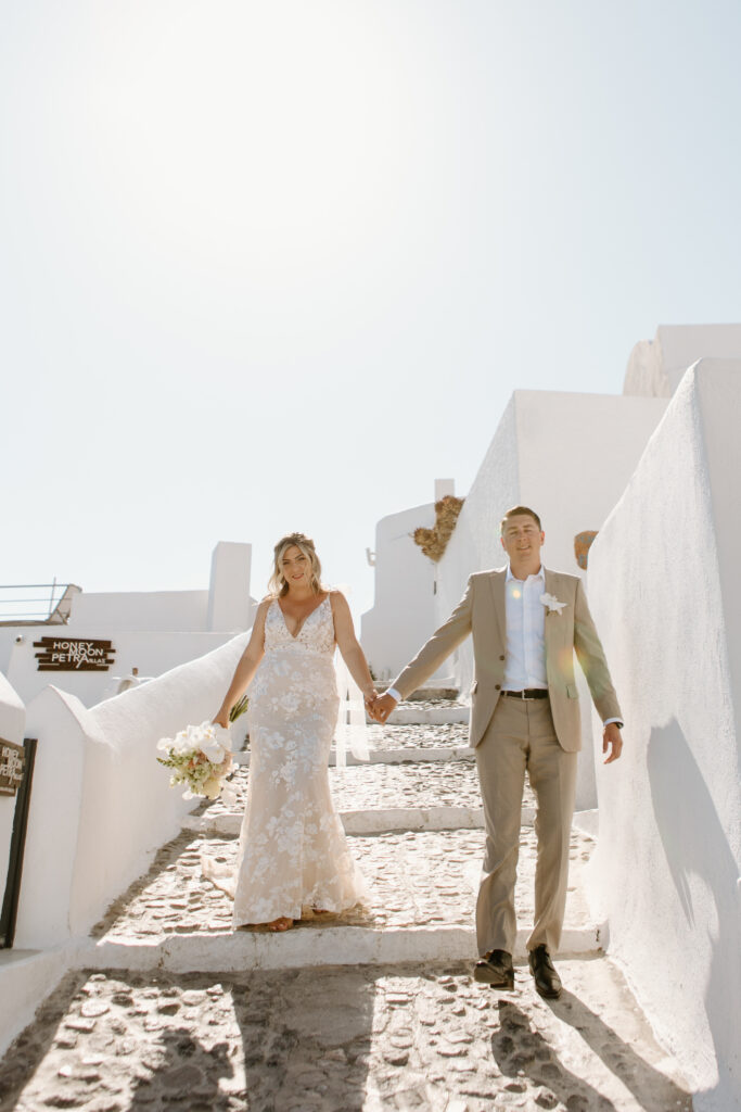 Bride and groom walking in santorini