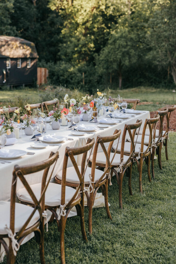 Vintage-inspired reception tables with candles, textured linens, and curated details.