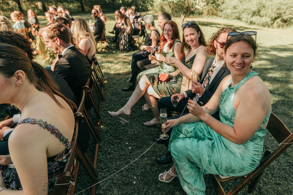 Guests holding the ceremony thread as the rings pass from person to person.