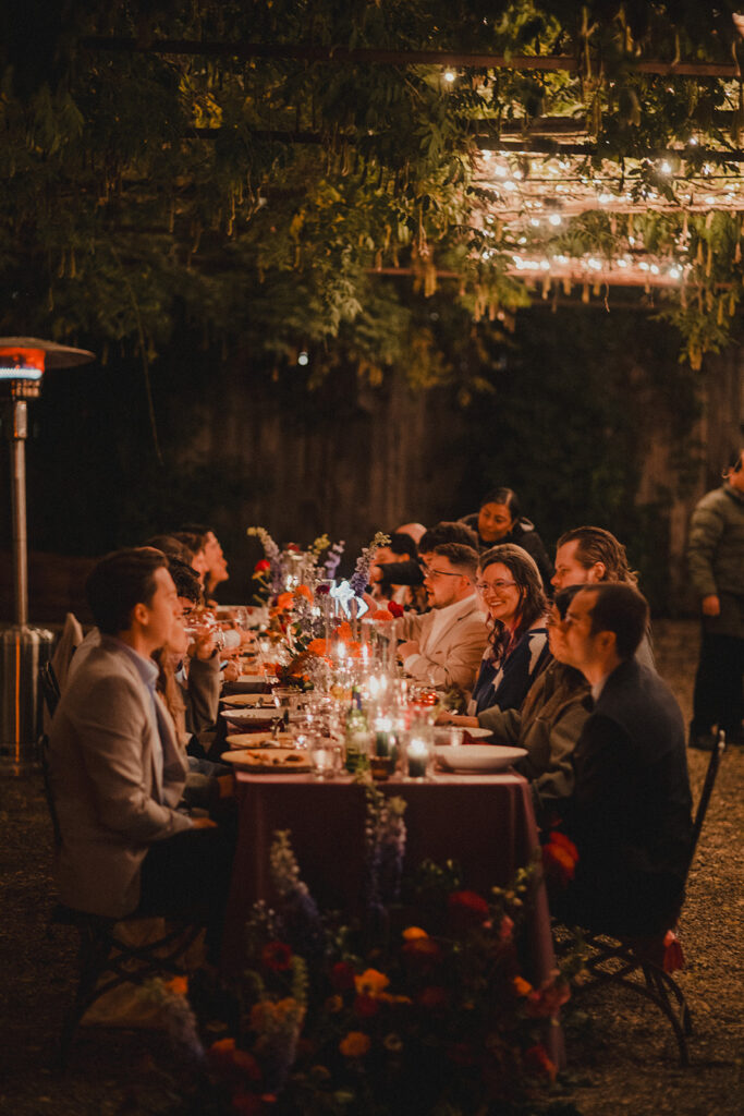 Guests toasting the newlyweds with glasses of sparkling wine.